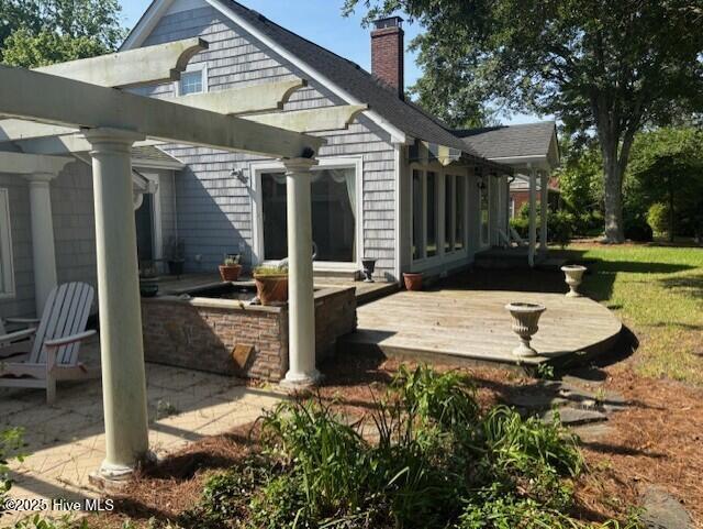 314 Madam Moores Ln, New Bern, NC 28562 - rear view of property with a wooden deck, a chimney, and a patio area