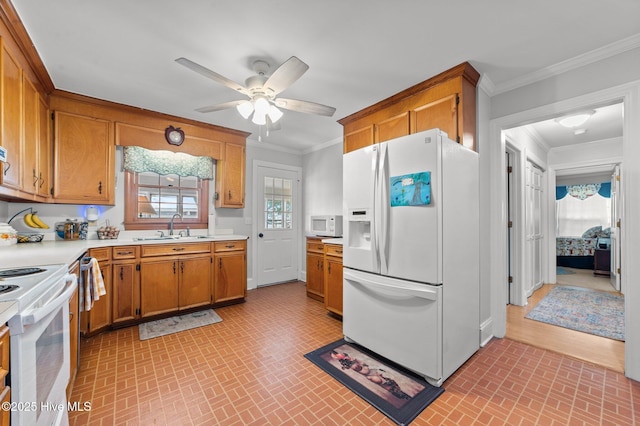 120 Oakes Rd, Hookerton, NC 28538 - kitchen featuring white appliances, a sink, brick patterned floors, light countertops, and brown cabinets