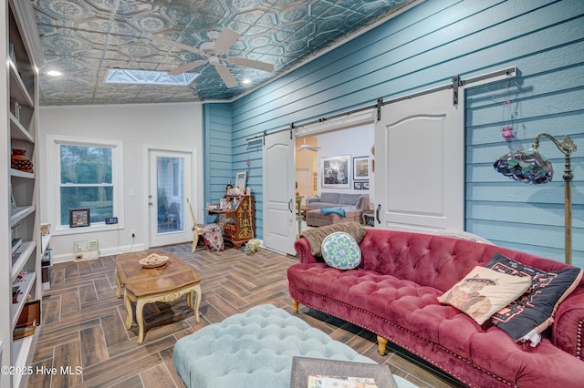 3508 Whispering Pines Ct, Wilmington, NC 28409 - living area with a barn door, ceiling fan, lofted ceiling, wood walls, and an ornate ceiling
