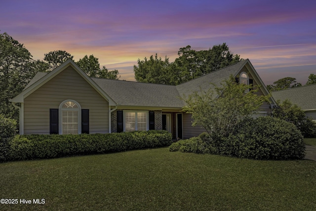 3508 Whispering Pines Ct, Wilmington, NC 28409 - view of front of property with a lawn, an attached garage, and roof with shingles