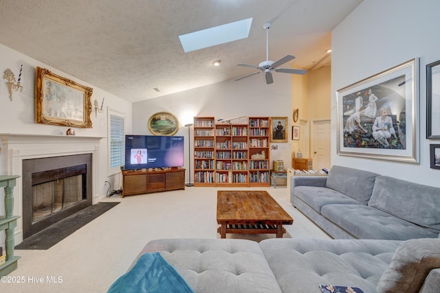 3508 Whispering Pines Ct, Wilmington, NC 28409 - carpeted living room featuring vaulted ceiling, a ceiling fan, a skylight, a fireplace with flush hearth, and recessed lighting