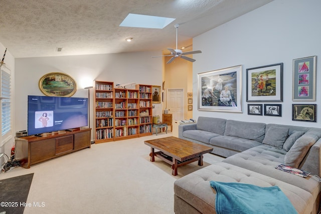 3508 Whispering Pines Ct, Wilmington, NC 28409 - carpeted living room with lofted ceiling, a skylight, a textured ceiling, and ceiling fan