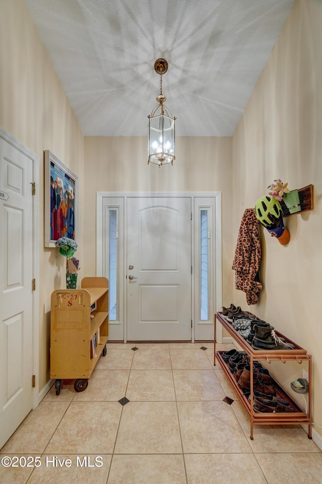 3508 Whispering Pines Ct, Wilmington, NC 28409 - tiled foyer with a chandelier and baseboards