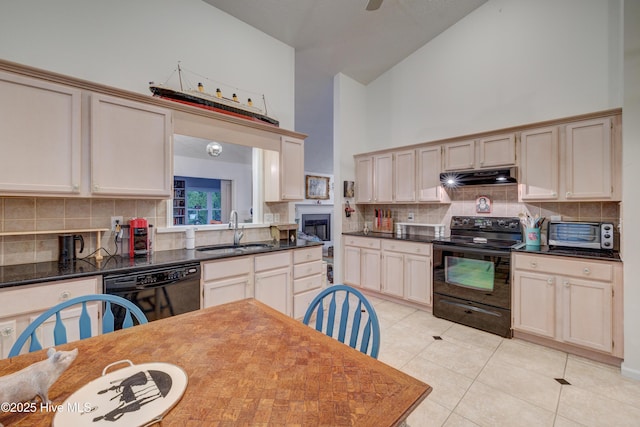 3508 Whispering Pines Ct, Wilmington, NC 28409 - kitchen featuring black appliances, under cabinet range hood, high vaulted ceiling, a sink, and backsplash