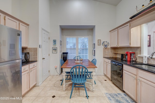 3508 Whispering Pines Ct, Wilmington, NC 28409 - kitchen featuring black appliances, a sink, a high ceiling, tasteful backsplash, and light tile patterned floors