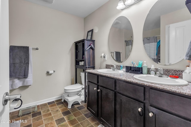 115 Joan Ct, New Bern, NC 28562 - full bathroom with baseboards, toilet, double vanity, and a shower with shower curtain