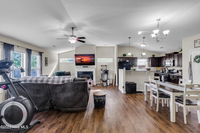 115 Joan Ct, New Bern, NC 28562 - living area featuring lofted ceiling, dark wood-style floors, ceiling fan, a chandelier, and a lit fireplace