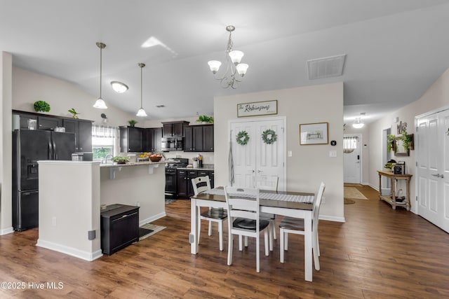 115 Joan Ct, New Bern, NC 28562 - dining space with a chandelier, dark wood finished floors, vaulted ceiling, and baseboards