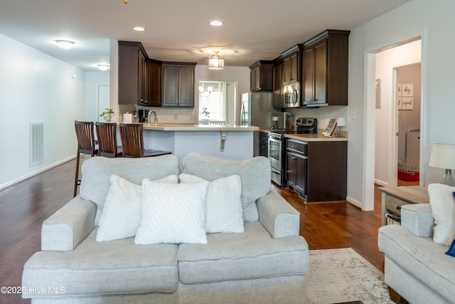 104 Northgate Ln, Clinton, NC 28328 - living area with dark wood-style flooring, baseboards, and recessed lighting