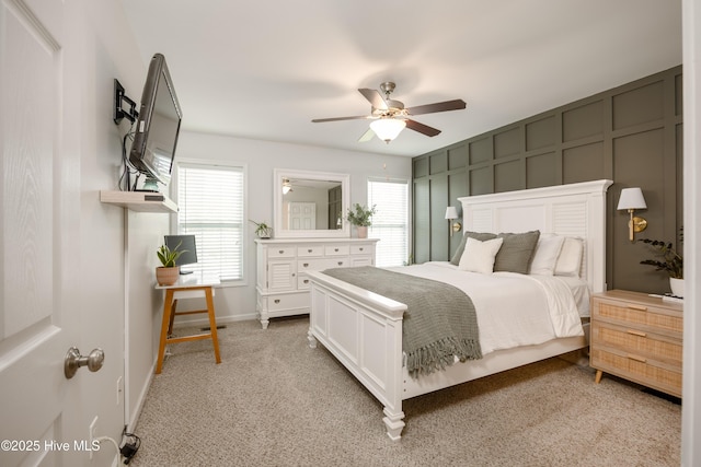 104 Northgate Ln, Clinton, NC 28328 - bedroom featuring multiple windows, light carpet, ceiling fan, baseboards, and a decorative wall