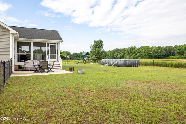 104 Northgate Ln, Clinton, NC 28328 - view of yard featuring a patio, a sunroom, and a playground