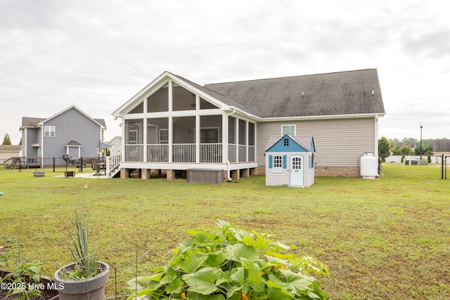 104 Northgate Ln, Clinton, NC 28328 - back of property featuring a sunroom, a yard, and roof with shingles