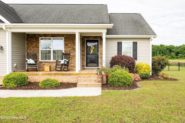 104 Northgate Ln, Clinton, NC 28328 - view of exterior entry with a porch and roof with shingles