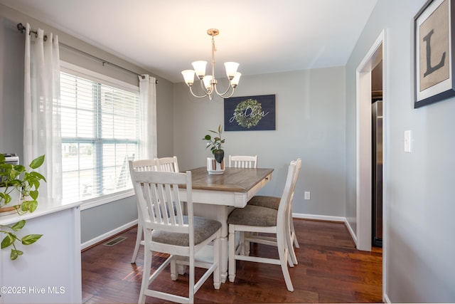 104 Northgate Ln, Clinton, NC 28328 - dining room featuring a chandelier, dark wood finished floors, and baseboards