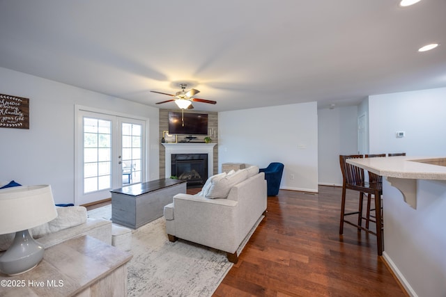 104 Northgate Ln, Clinton, NC 28328 - living room featuring a ceiling fan, a fireplace, dark wood-style flooring, baseboards, and recessed lighting