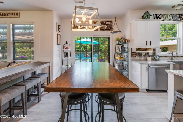 403 Stanford Ct, Maysville, NC 28555 - dining area featuring a chandelier and light wood finished floors
