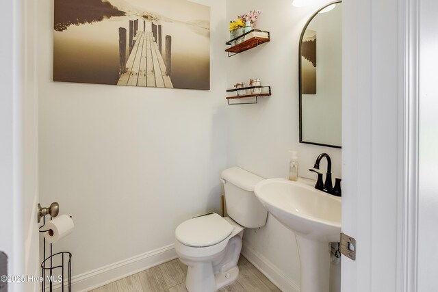 403 Stanford Ct, Maysville, NC 28555 - half bath featuring toilet, baseboards, and wood finished floors