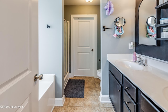 403 Stanford Ct, Maysville, NC 28555 - bathroom featuring toilet, double vanity, a shower stall, tile patterned floors, and a garden tub