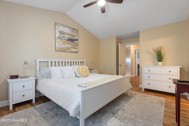 bedroom with wood finished floors, lofted ceiling, and a ceiling fan