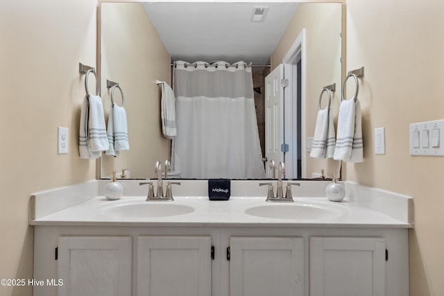 full bathroom with double vanity and a shower with shower curtain