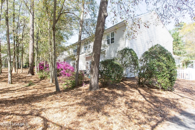 view of home's exterior featuring fence