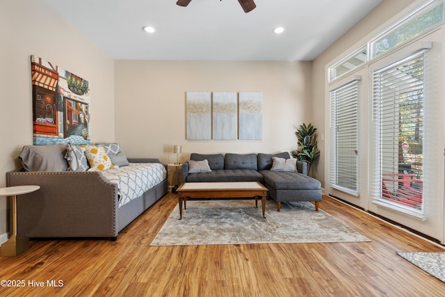 living area featuring a ceiling fan, light wood finished floors, and recessed lighting