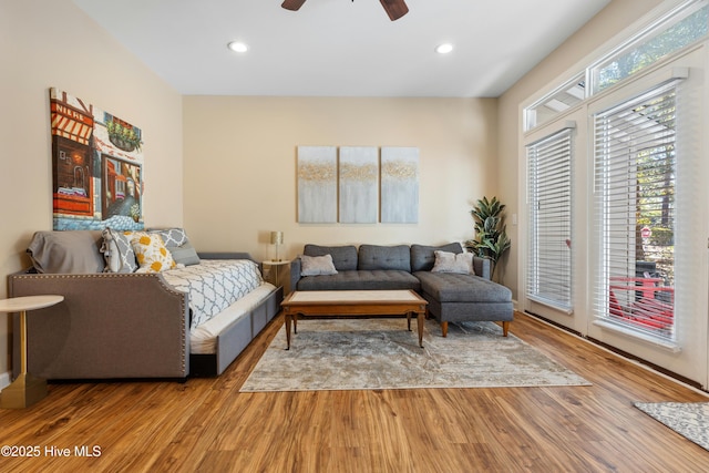 living area featuring wood finished floors, a ceiling fan, and recessed lighting