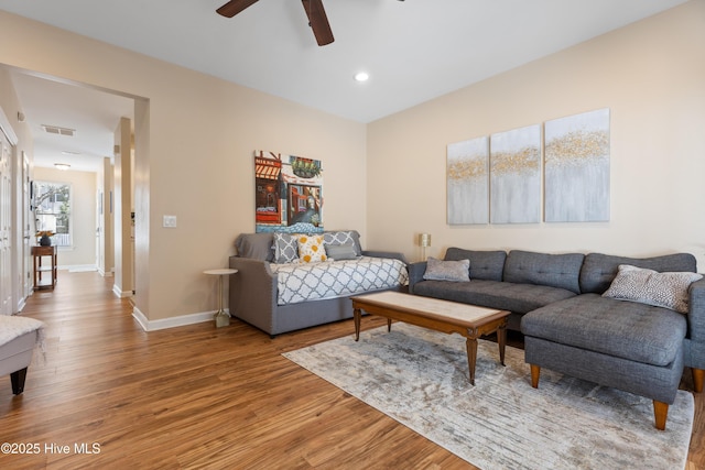 living room with light wood finished floors, ceiling fan, baseboards, and recessed lighting
