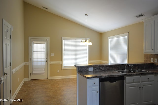 kitchen with dishwasher, a sink, a peninsula, dark countertops, and vaulted ceiling