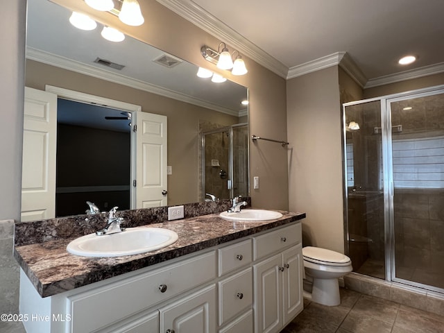 bathroom with a shower stall, double vanity, toilet, tile patterned floors, and ornamental molding