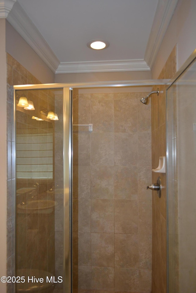 bathroom featuring a stall shower and crown molding
