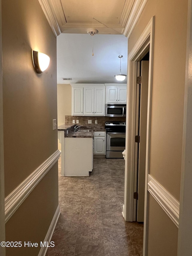 corridor with attic access and a sink
