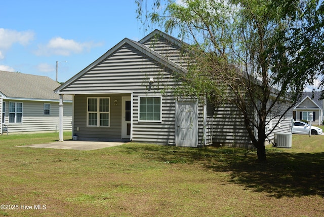 back of property featuring a yard, central AC, and a patio