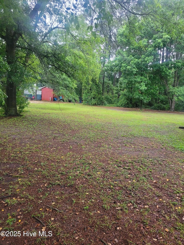 view of green lawn featuring an outdoor structure