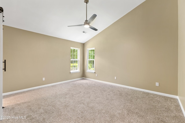 carpeted spare room featuring a ceiling fan, baseboards, and high vaulted ceiling
