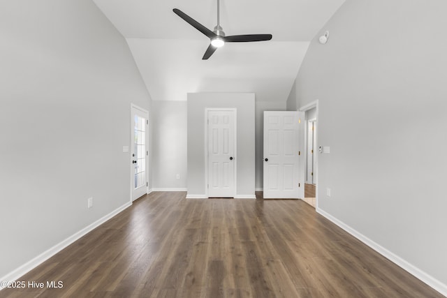 unfurnished bedroom with dark wood-style floors, baseboards, high vaulted ceiling, and a ceiling fan