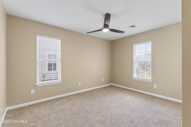 carpeted spare room with baseboards and ceiling fan