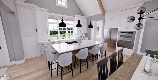 2112 Arnold Palmer Dr, Shallotte, NC 28470 - dining space with high vaulted ceiling and light wood-type flooring