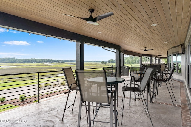 2112 Arnold Palmer Dr, Shallotte, NC 28470 - sunroom featuring a ceiling fan, a rural view, and outdoor dining space
