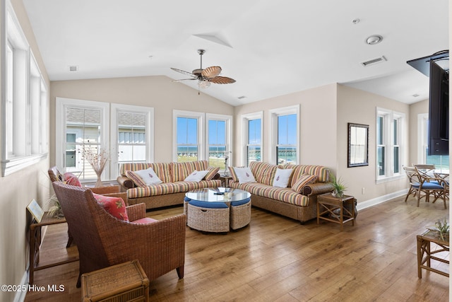 2112 Arnold Palmer Dr, Shallotte, NC 28470 - living room featuring light wood-style flooring, healthy amount of natural light, vaulted ceiling, a ceiling fan, and baseboards