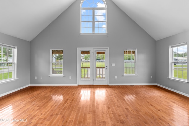 149 Lee St, Holly Ridge, NC 28445 - unfurnished living room with high vaulted ceiling, light wood finished floors, plenty of natural light, and baseboards
