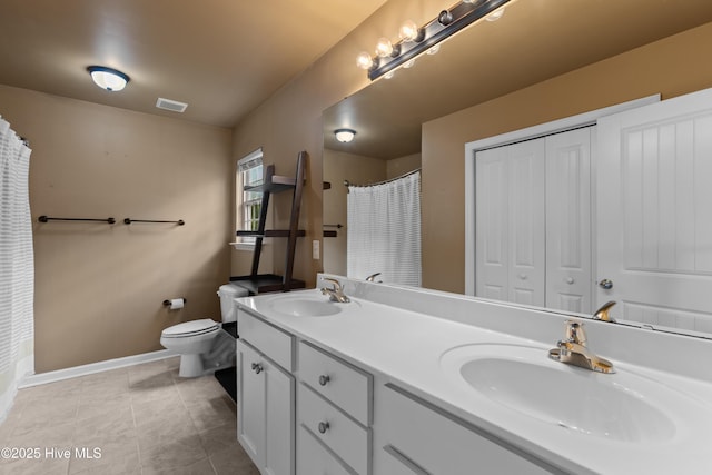 149 Lee St, Holly Ridge, NC 28445 - bathroom with double vanity, toilet, baseboards, tile patterned flooring, and a shower with curtain