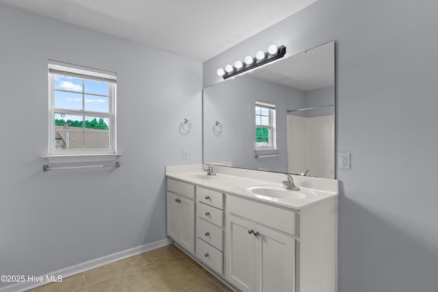 149 Lee St, Holly Ridge, NC 28445 - full bath with double vanity, healthy amount of natural light, baseboards, and tile patterned flooring