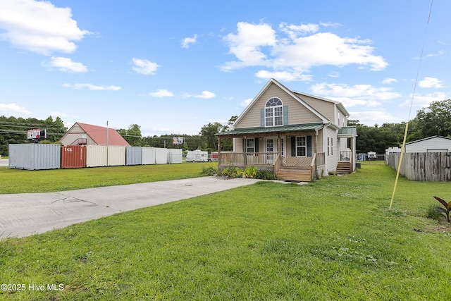 149 Lee St, Holly Ridge, NC 28445 - view of front of property featuring a porch, driveway, and metal roof
