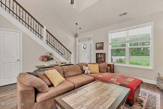 11 Bedford Cir, Pinehurst, NC 28374 - living area with wood finished floors, stairway, vaulted ceiling, and baseboards