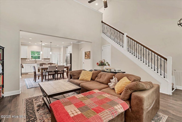 11 Bedford Cir, Pinehurst, NC 28374 - living room with dark wood-type flooring, stairs, ceiling fan, a high ceiling, and recessed lighting