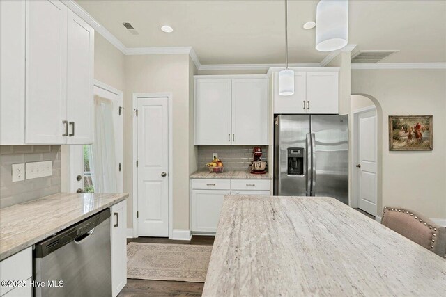 11 Bedford Cir, Pinehurst, NC 28374 - kitchen with appliances with stainless steel finishes, crown molding, white cabinets, tasteful backsplash, and dark wood-type flooring