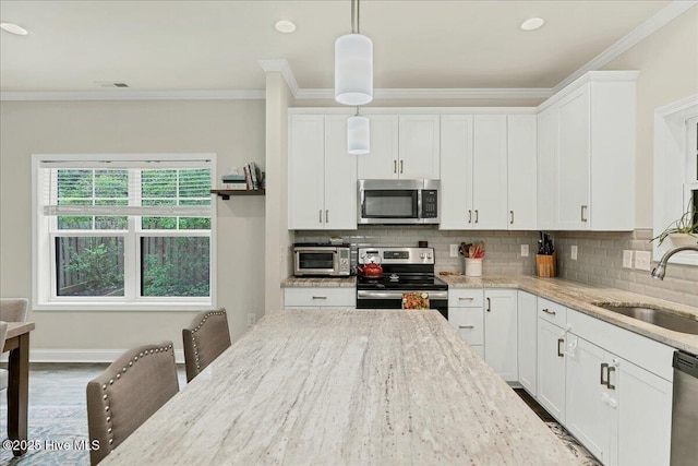 11 Bedford Cir, Pinehurst, NC 28374 - kitchen with appliances with stainless steel finishes, a sink, ornamental molding, tasteful backsplash, and white cabinetry