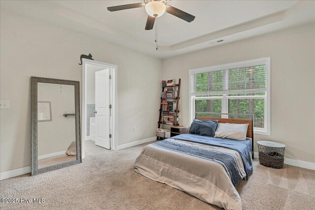 11 Bedford Cir, Pinehurst, NC 28374 - bedroom with carpet floors, baseboards, a tray ceiling, and ceiling fan