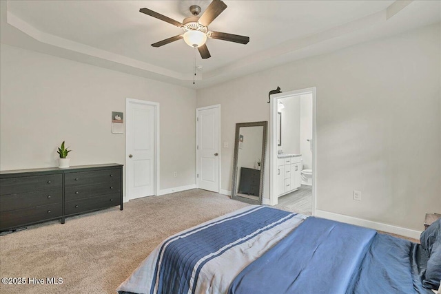 11 Bedford Cir, Pinehurst, NC 28374 - carpeted bedroom with a raised ceiling, baseboards, ensuite bathroom, and ceiling fan